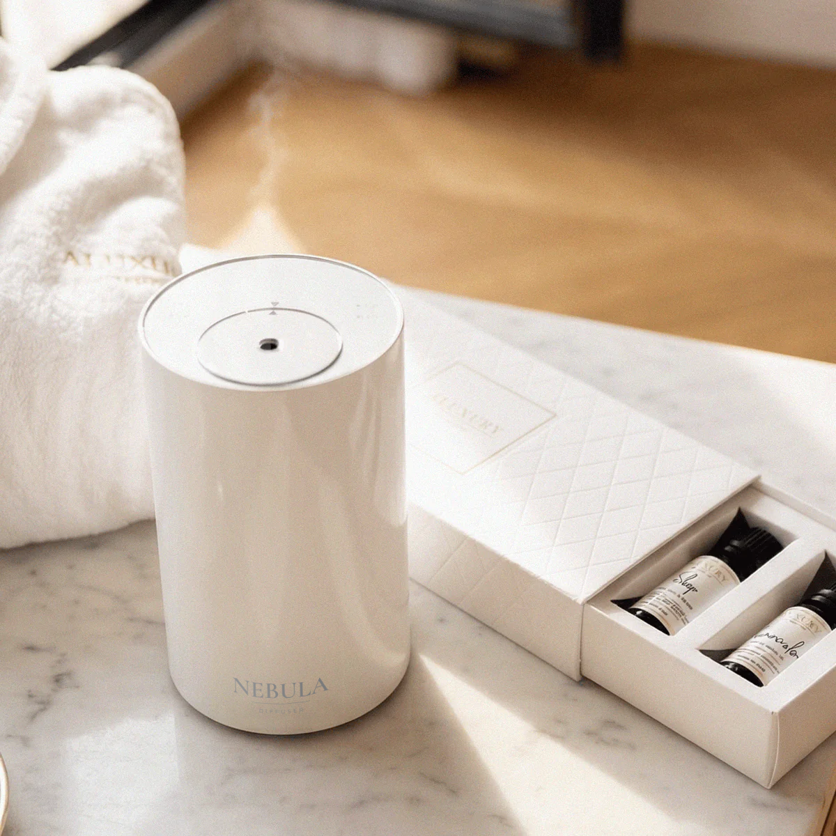 Nebula diffuser in white with a box of diffuser oils