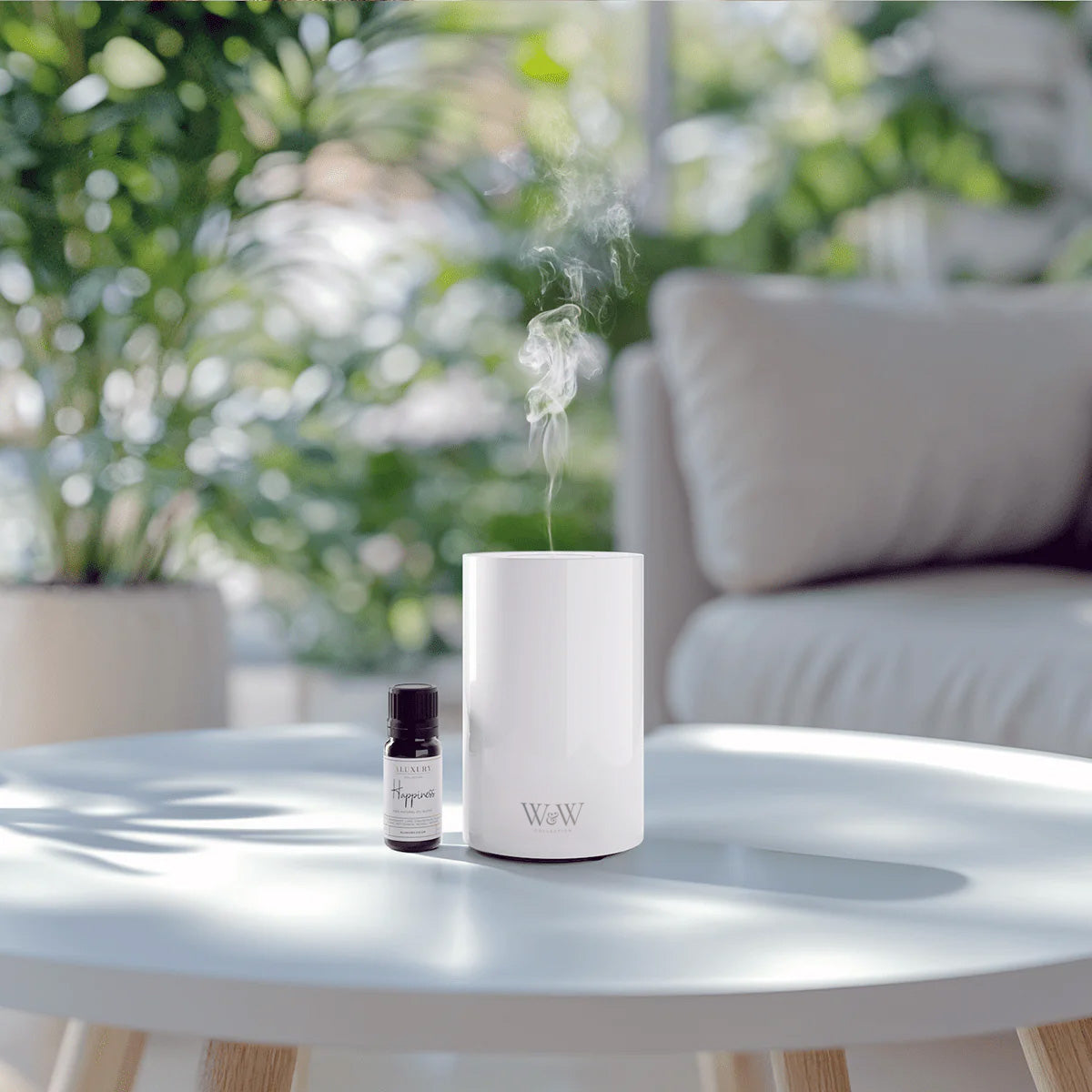 portable battery-operated waterless diffuser in white with essential oil blend bottle