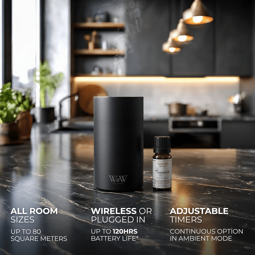 Black wireless diffuser and essential oil bottle on a kitchen counter with product features displayed.