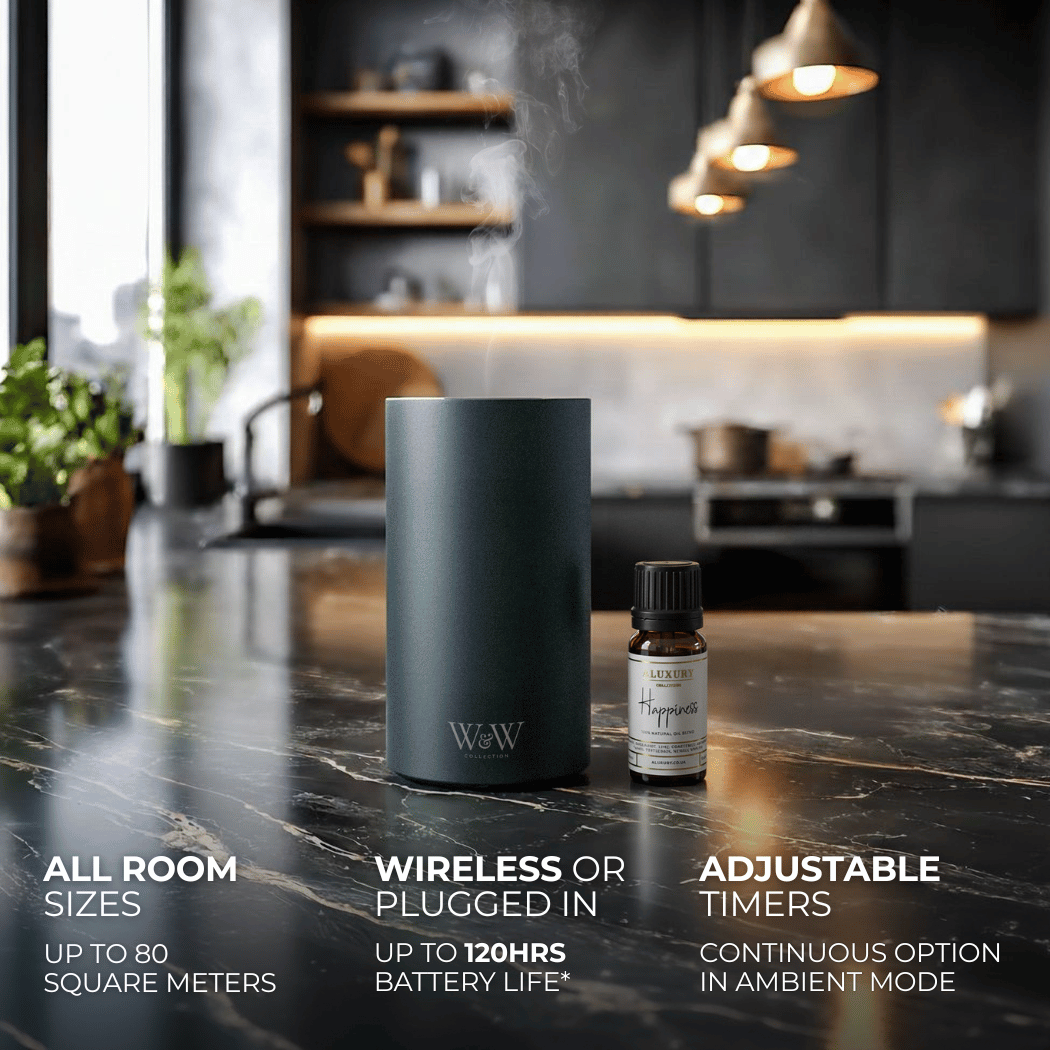 Grey wireless diffuser and essential oil bottle on a kitchen counter with product features displayed.