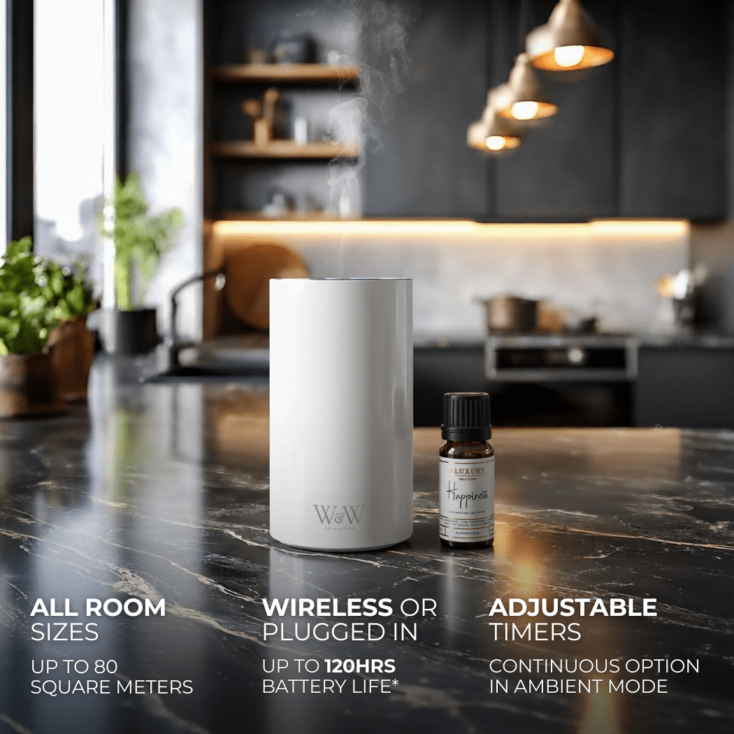 White wireless diffuser and essential oil bottle on a kitchen counter with product features displayed.