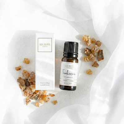 Luxury frankincense essential oil bottle with frankincense resin on a white fabric background