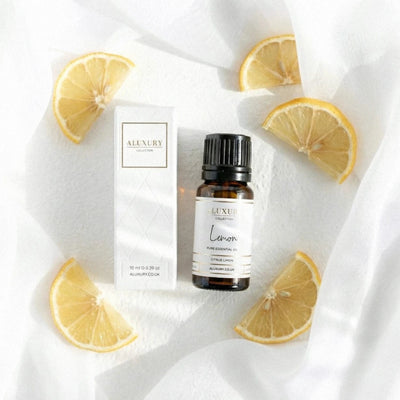 Luxury Lemon essential oil bottle and packaging with lemon slices on a white fabric background